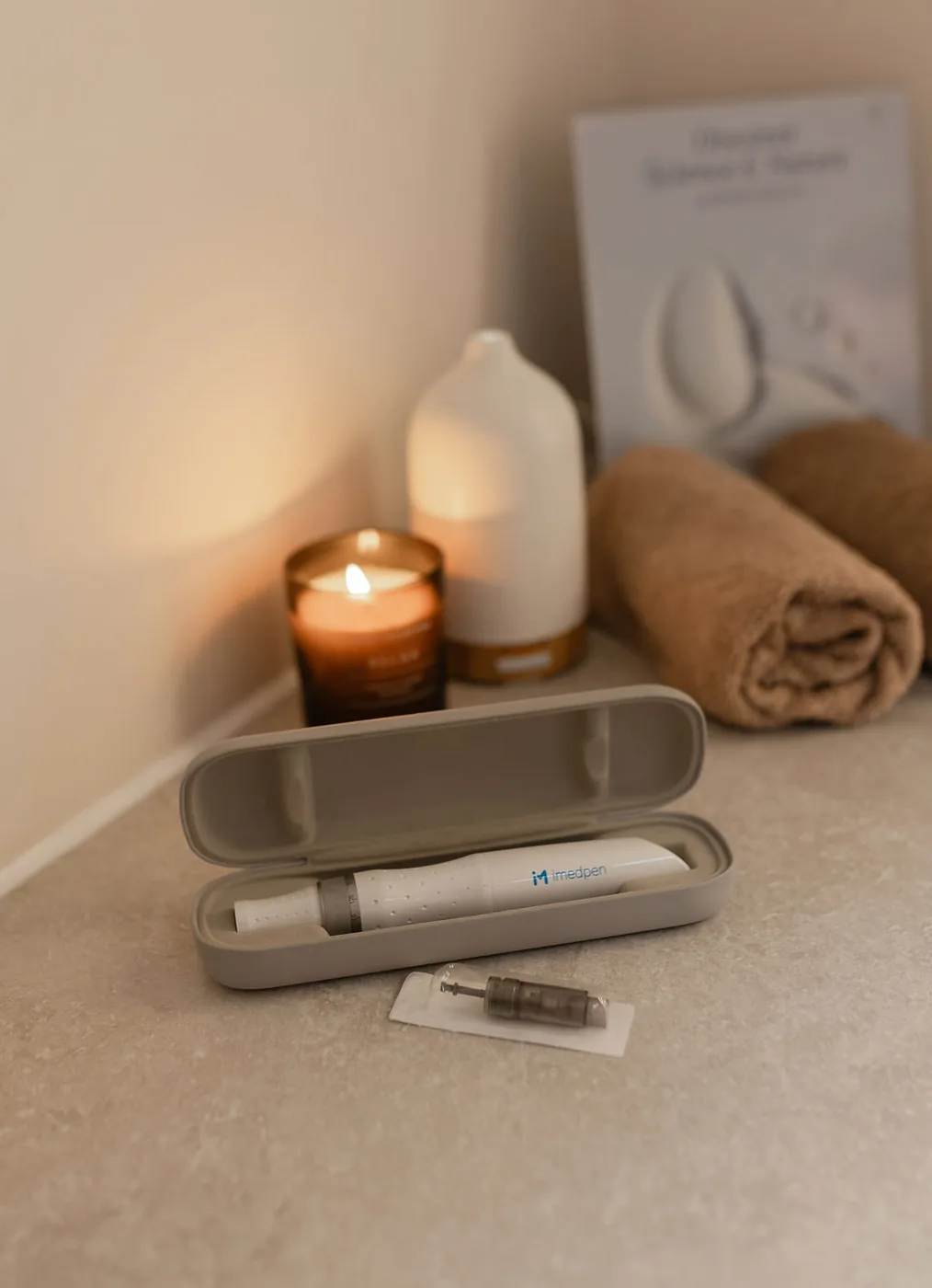 The imedpen microneedling device beside a candle at The Skin Lounge Bristol